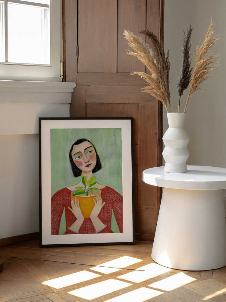 Woman Holding Green Plant, arte de Sharyn Bursic enmarcado en una pared