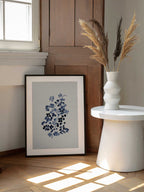 Indigo Floral Bloom, arte de Danushka Abeygoda enmarcado en una pared